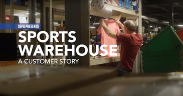 A warehouse worker holding a shirt to inspect with sports warehouse customer story in text