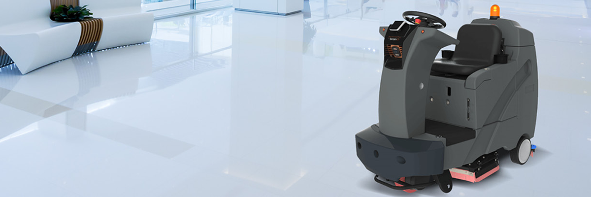 A robotic floor scrubber running in commercial building lobby