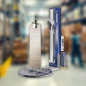 A Robopac stretch wrapper in warehouse environment with blurred background