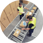 Two warehouse workers working on packages on a conveyor belt