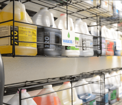 Shelves full of WAXIE chemical including disinfectants