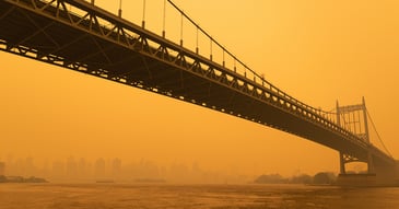 A bridge in New York with smokes from wildlfire effecting in the environment