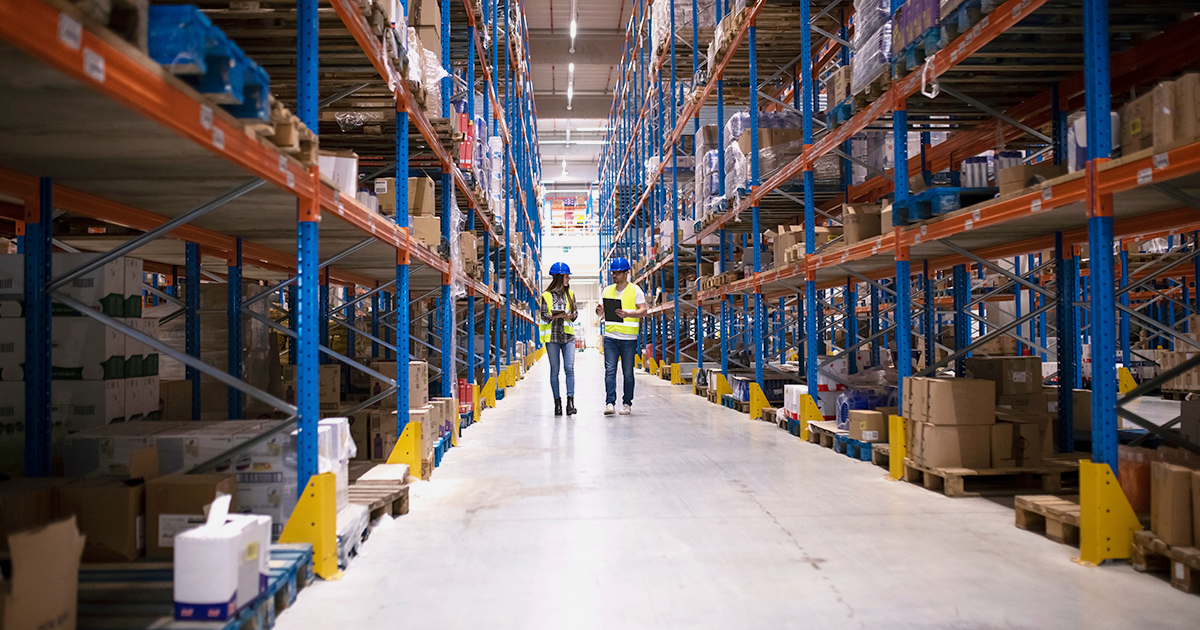 two people walking in a large distribution center